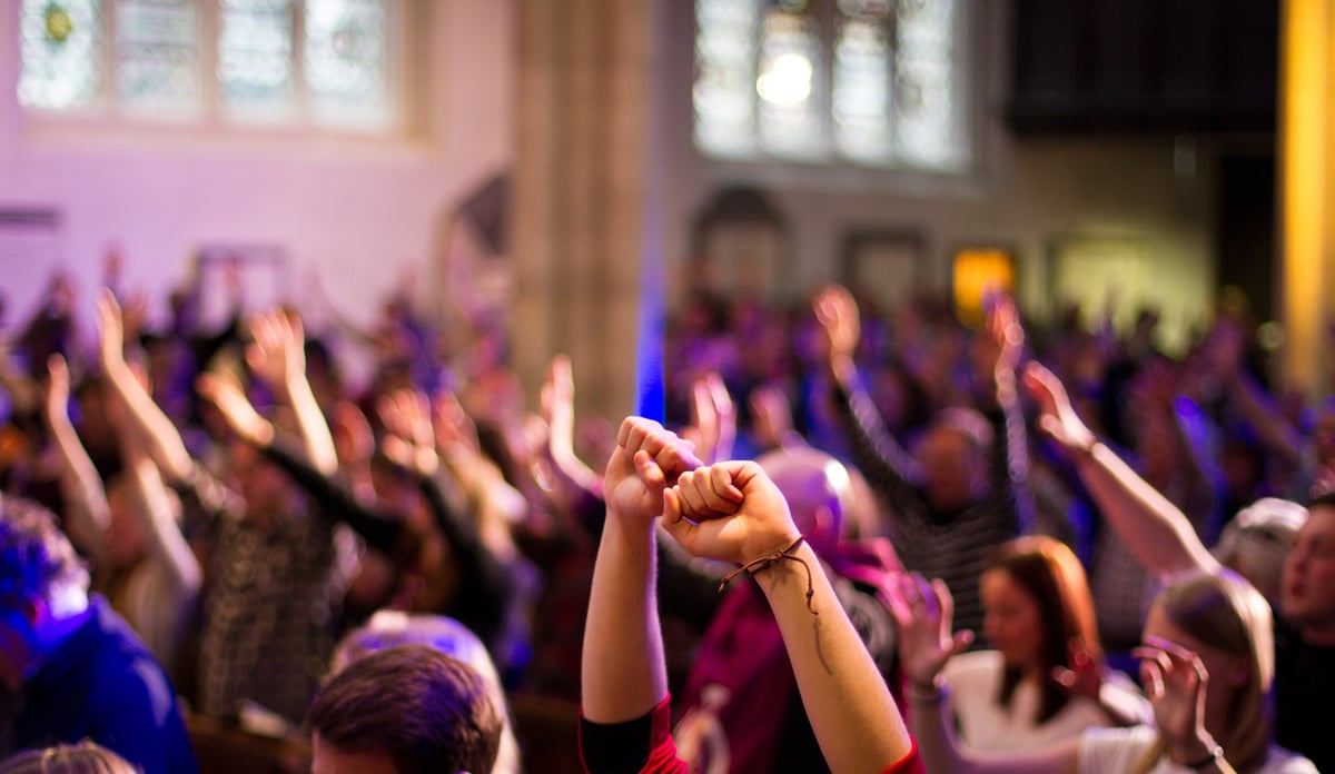 York, United Kingdom - May 15, 2016: A congregation worship with raised hands at a Christian church service held at St Michael Le Belfry.